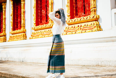 Woman standing against wall in a building