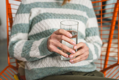 Midsection of woman using mobile phone