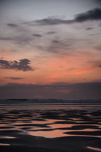 Scenic view of sea against romantic sky at sunset