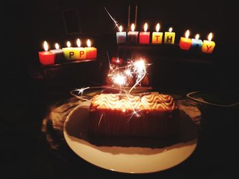 Illuminated candles on table