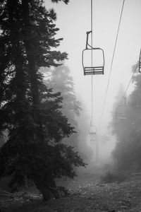 Low angle view of overhead cable car against sky