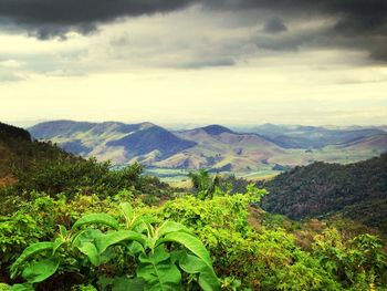 Scenic view of mountains against cloudy sky