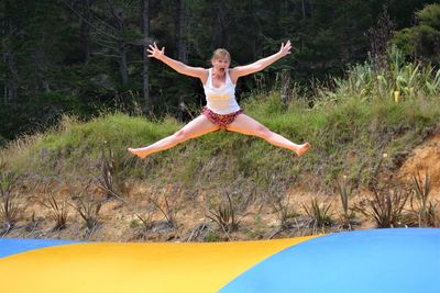 Portrait of woman jumping on bouncy castle
