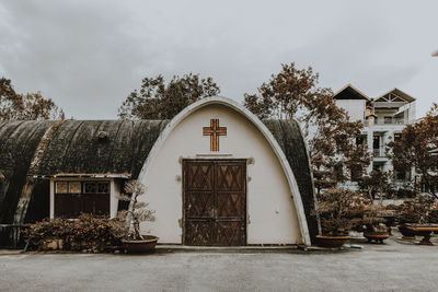 Exterior of church against cloudy sky