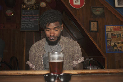 A young man at a bar.