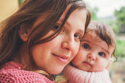 Close-up portrait of mother with baby