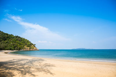 Scenic view of beach against blue sky