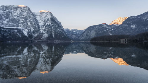 Beautiful alpine lake reflecting surrounding peaks during sunrise, panorama, austria, europe