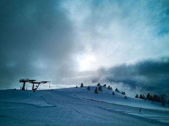 People skiing on snowcapped mountain against sky