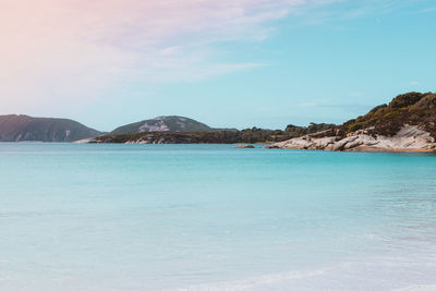 Scenic view of sea and mountains against sky