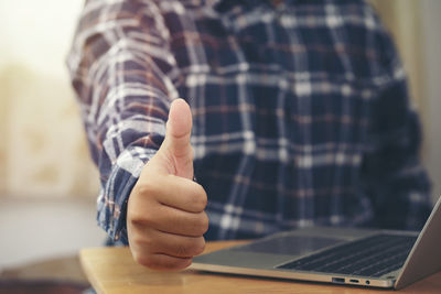 Midsection of man using mobile phone