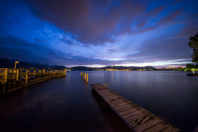 Bridge over river against sky at night