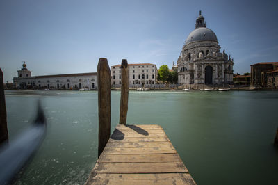 View of canal by building against sky