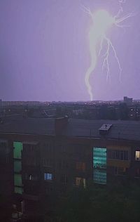 Buildings in city against sky at night