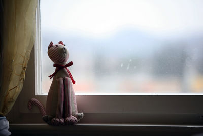 Close-up of stuffed toy on window sill