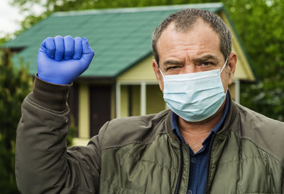 Adult man in medical mask outdoors portrait