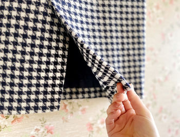 Cropped hand of woman holding fabric