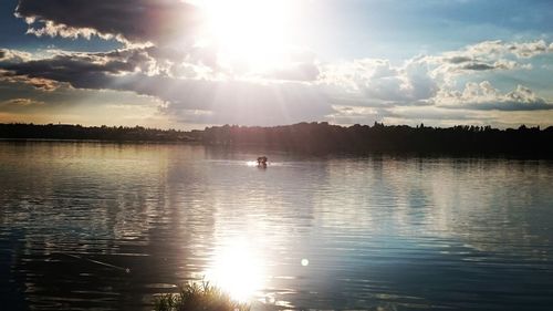 Scenic view of lake against cloudy sky