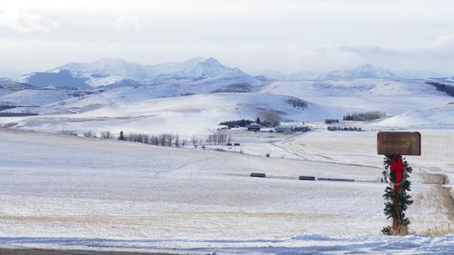 Scenic view of snow covered mountains against sky