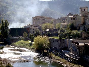 River amidst buildings against sky