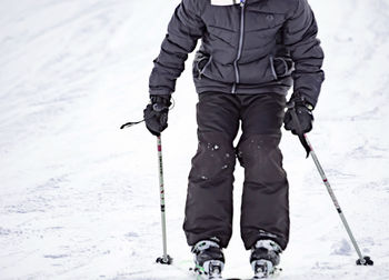 Full length of person standing on snow covered mountain