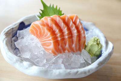 Close-up of sashimi on ice in bowl
