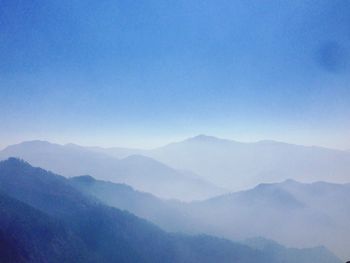 Scenic view of mountains against clear blue sky on sunny day