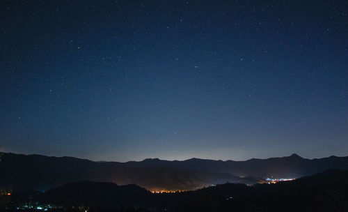 Scenic view of mountains against sky at night