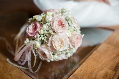 Close-up of bouquet on glass table during wedding