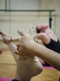 Close-up of ballet dancer stretching in studio
