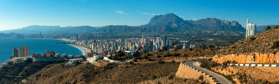 Panoramic view of landscape and mountains against clear blue sky