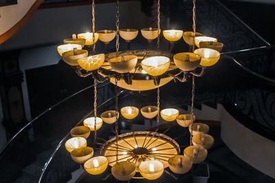 Low angle view of illuminated pendant light hanging from ceiling