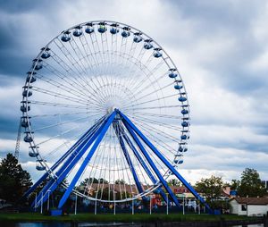 Low angle view of ferris wheel against sky