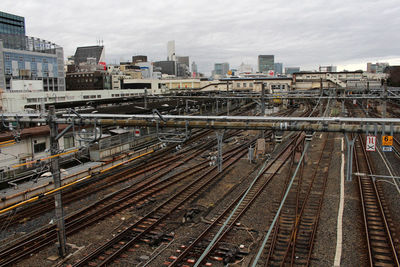 High angle view of railroad tracks in city against sky