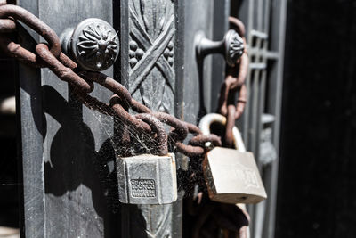 Close-up of padlocks hanging on railing