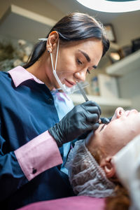 Side view of doctor examining patient