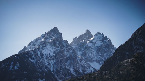 Scenic view of snowcapped mountains against clear sky