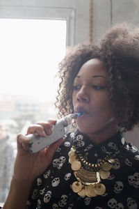 Young woman using an electronic cigarette