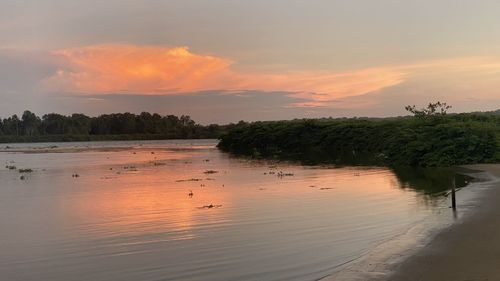 Scenic view of lake against orange sky