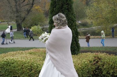 Rear view of people walking on field