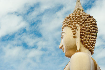 Low angle view of statue against temple against sky