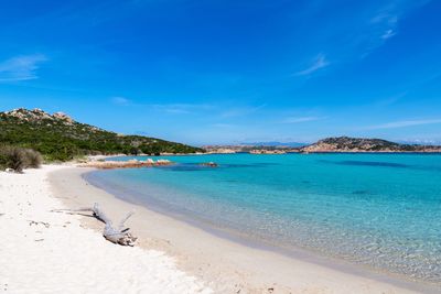 Scenic view of beach against blue sky