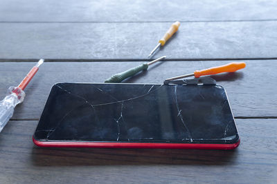 High angle view of red paint on table