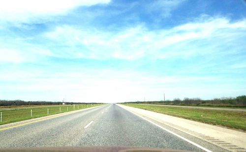 Country road against sky