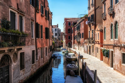 Venice canal lined with old houses taken during a summer sunlight
