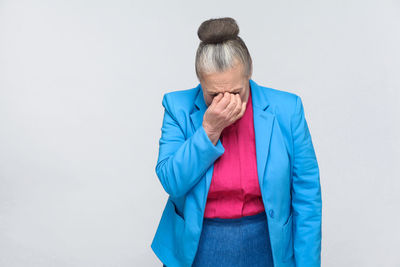 Mid adult woman standing against white background