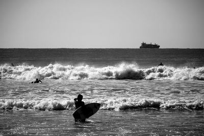 Rear view of surfer in sea