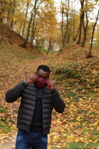 Full length of woman standing in forest during autumn