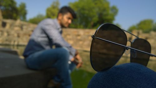 Rear view of woman sitting on bench