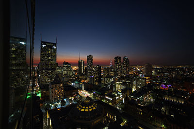 Illuminated buildings in city at night